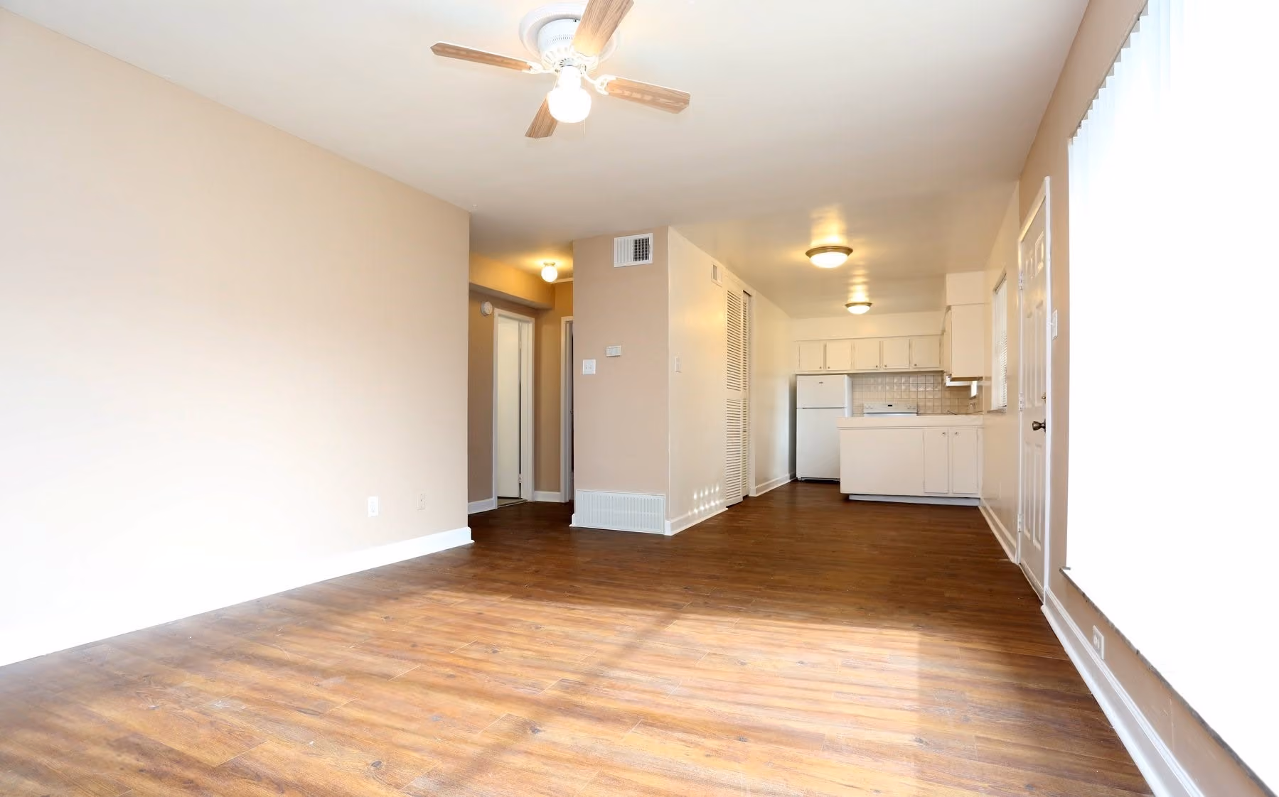 Unfurnished Living area with view of kitchen and hallway