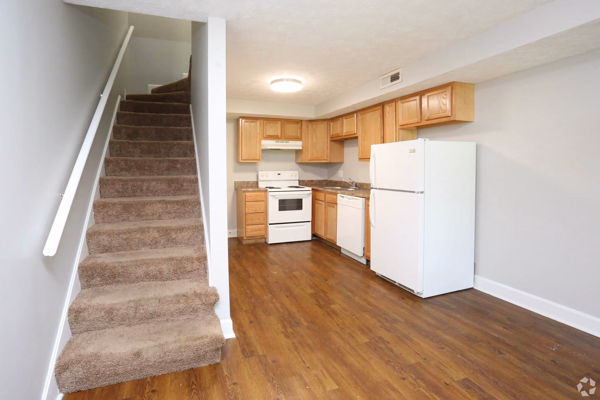 Staircase to second floor and dining and kitchen areas