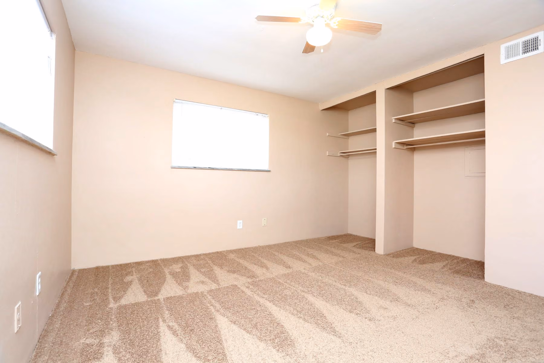 Unfurnished bedroom with carpet, window and closet