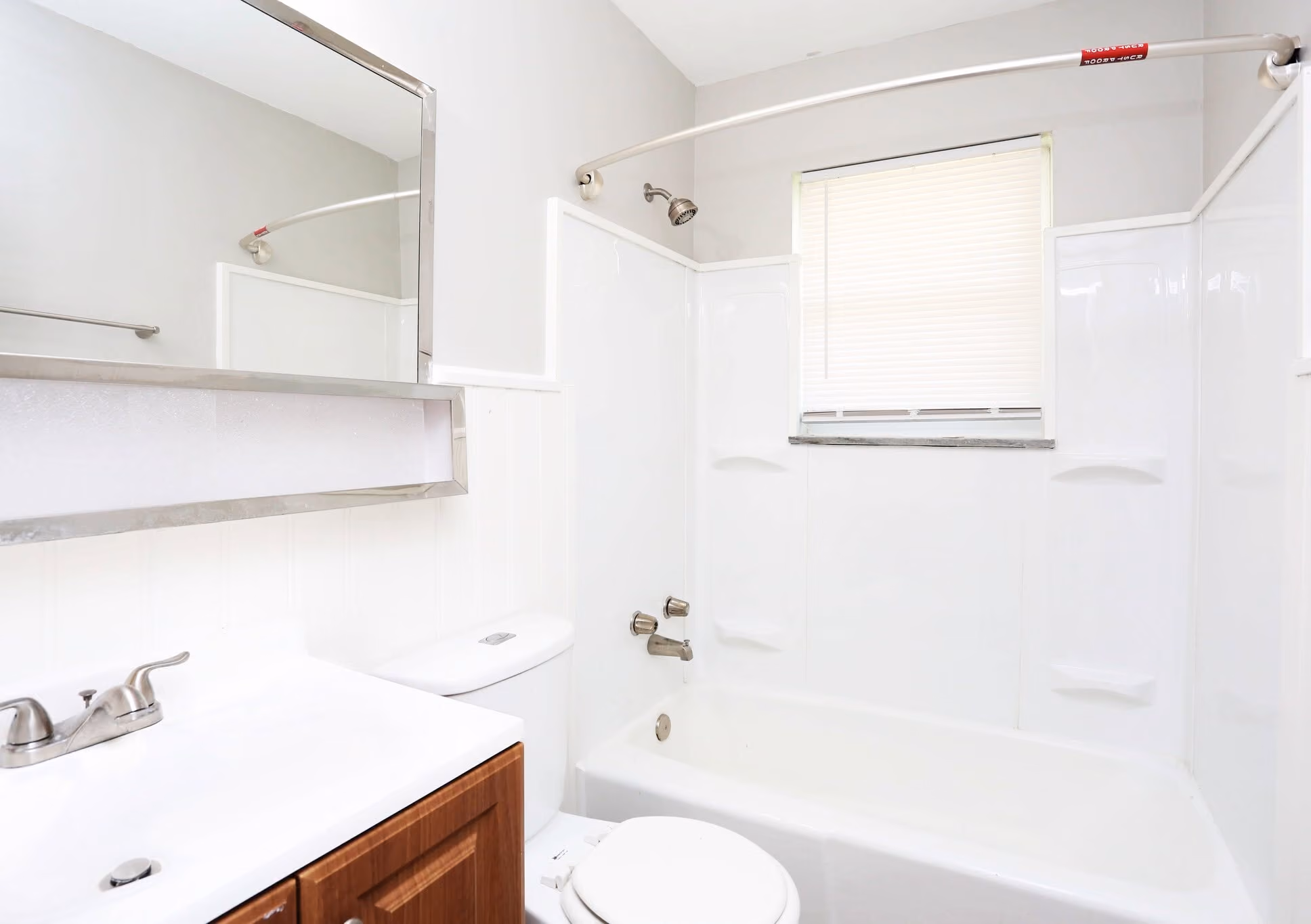 Bathroom with brown cabinets and shower tub combo
