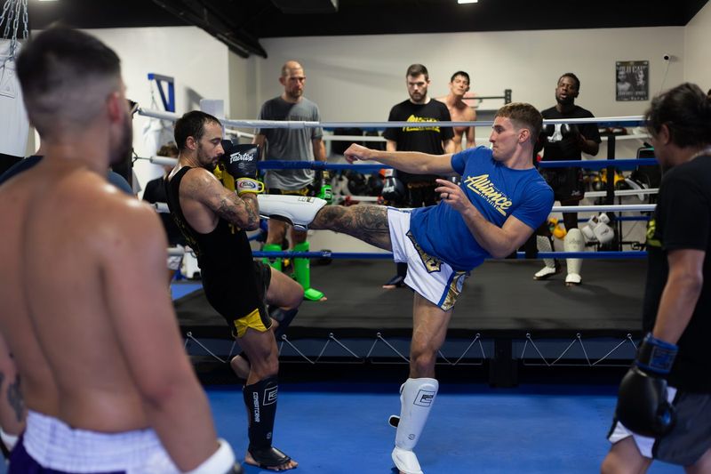 Student landing a kick on a partner during Advanced Muay Thai class in Cedar Park, TX