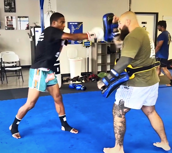 Boxer landing a cross on a focus mitt during boxing training at Alliance Thai Boxing Academy in Cedar Park, TX