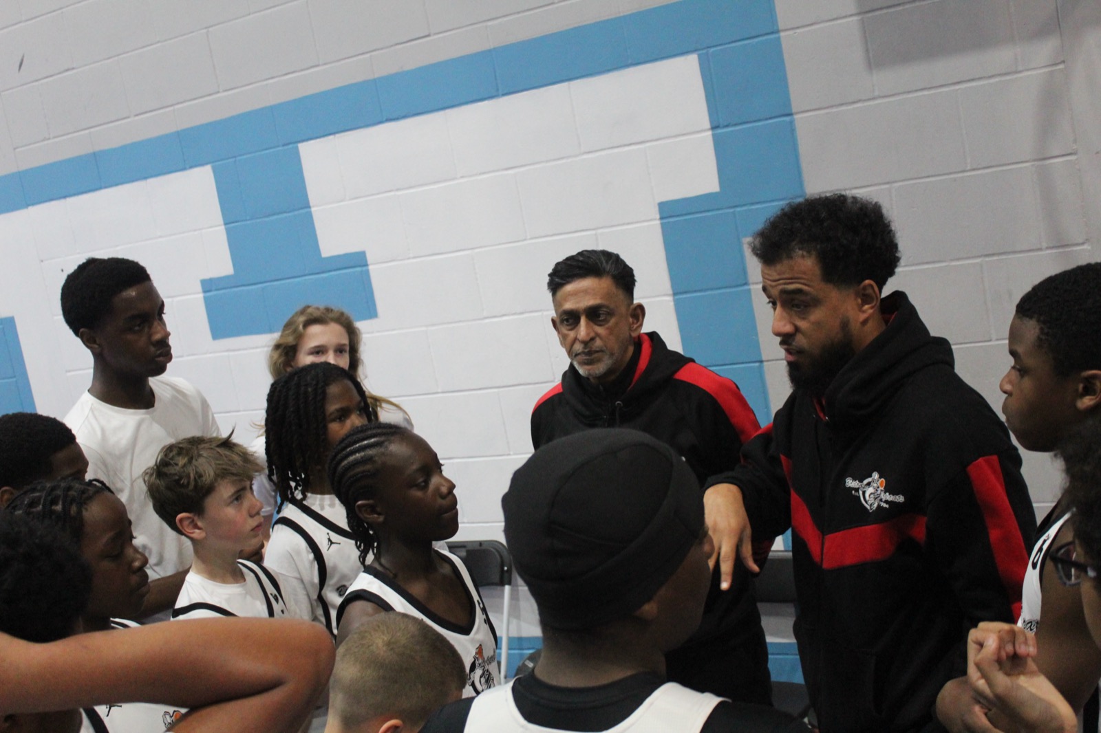 Brixton Topcats coaches giving a team talk to young players