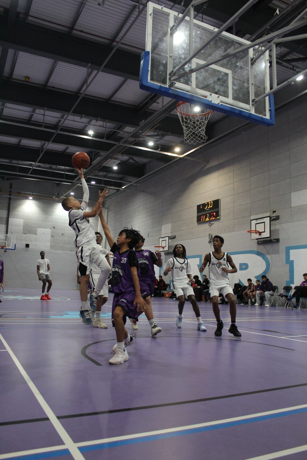 Brixton Topcats Under-13 player rising for a layup in the 2026 BDL final