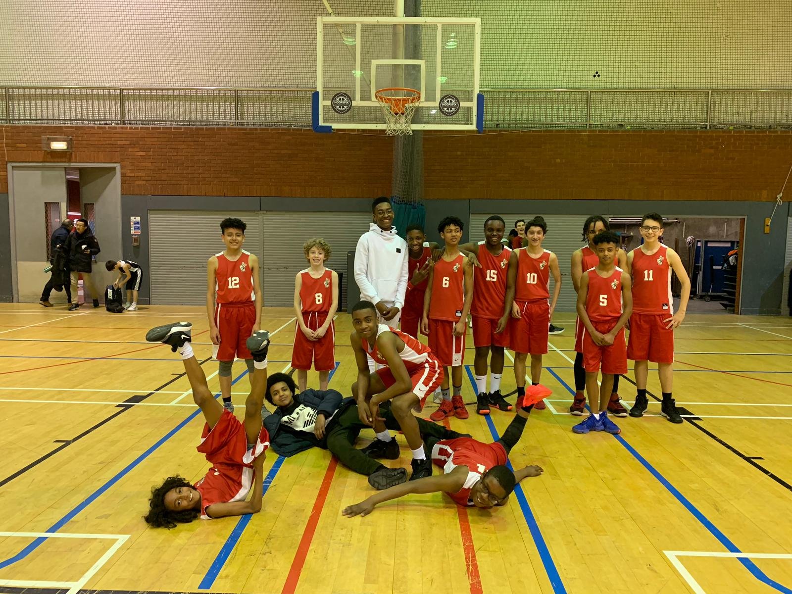 A Brixton Topcats youth squad having fun on court after a game