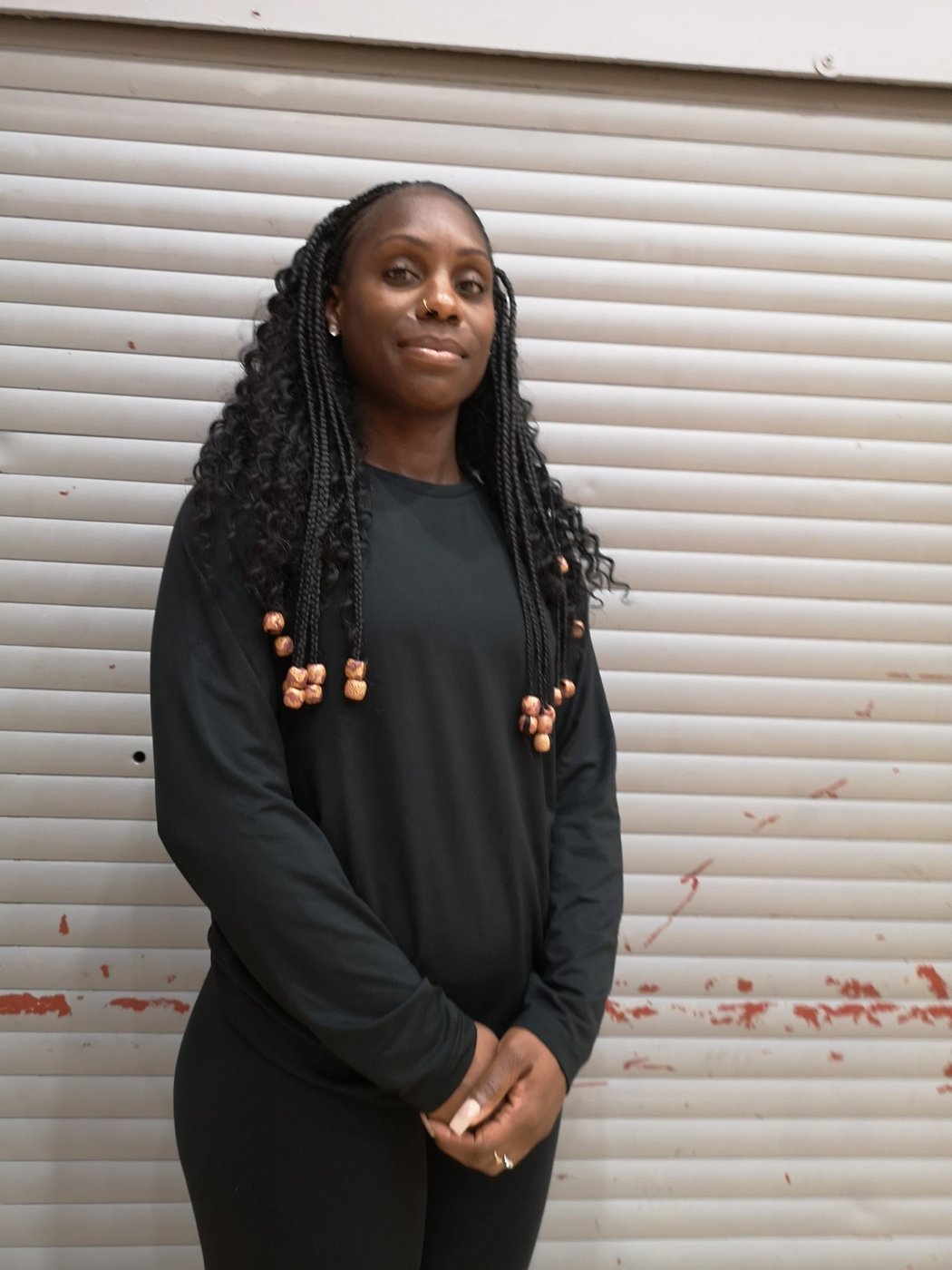 Coach Moji Odusanya standing in a black Brixton Topcats top