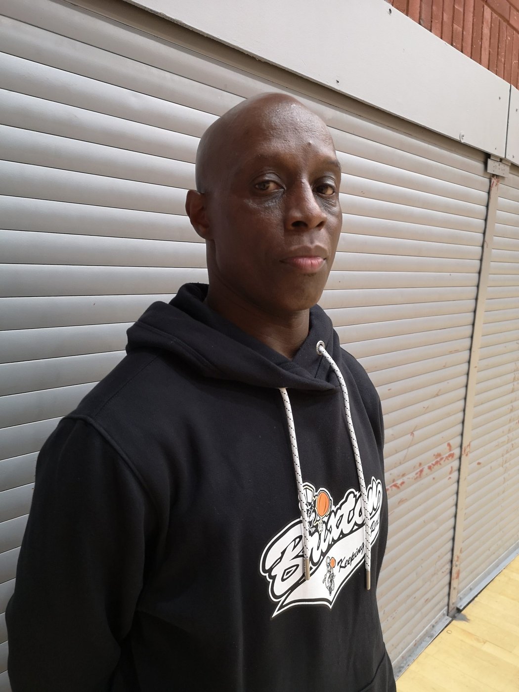 Coach Ronnie Baker in a Brixton Topcats hoodie