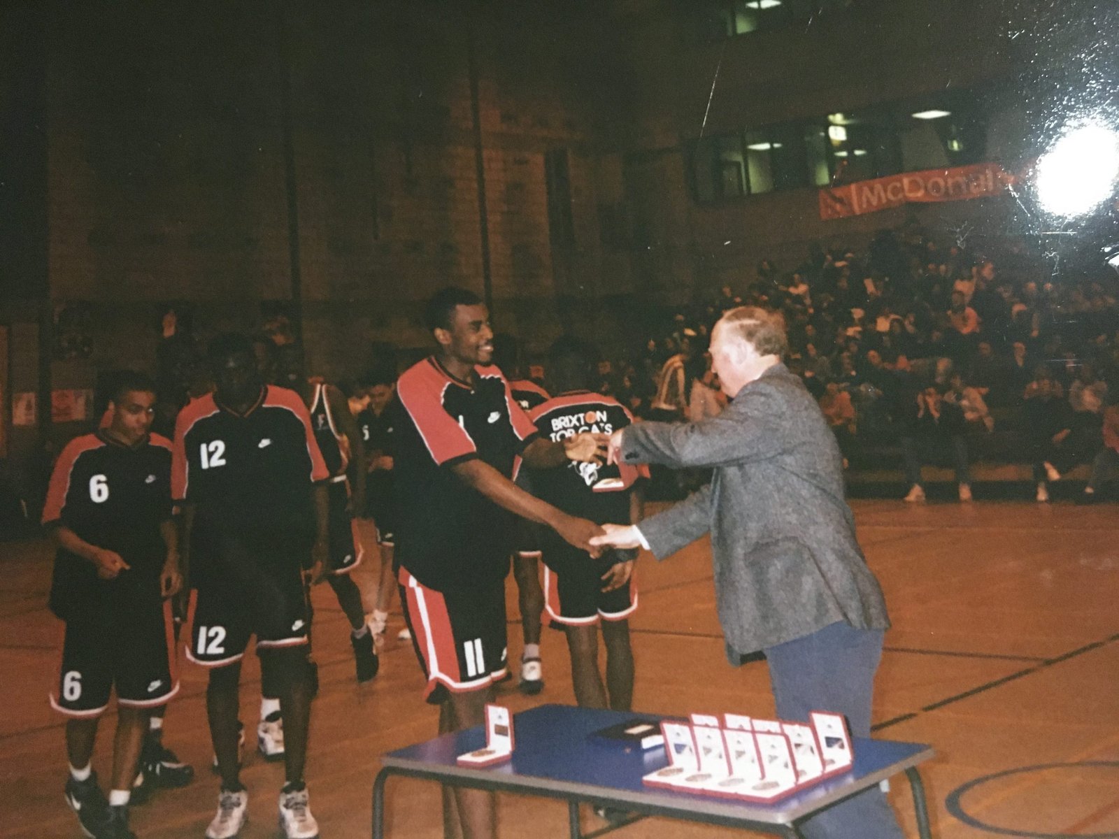Brixton Topcats players receive awards at a 1990s presentation