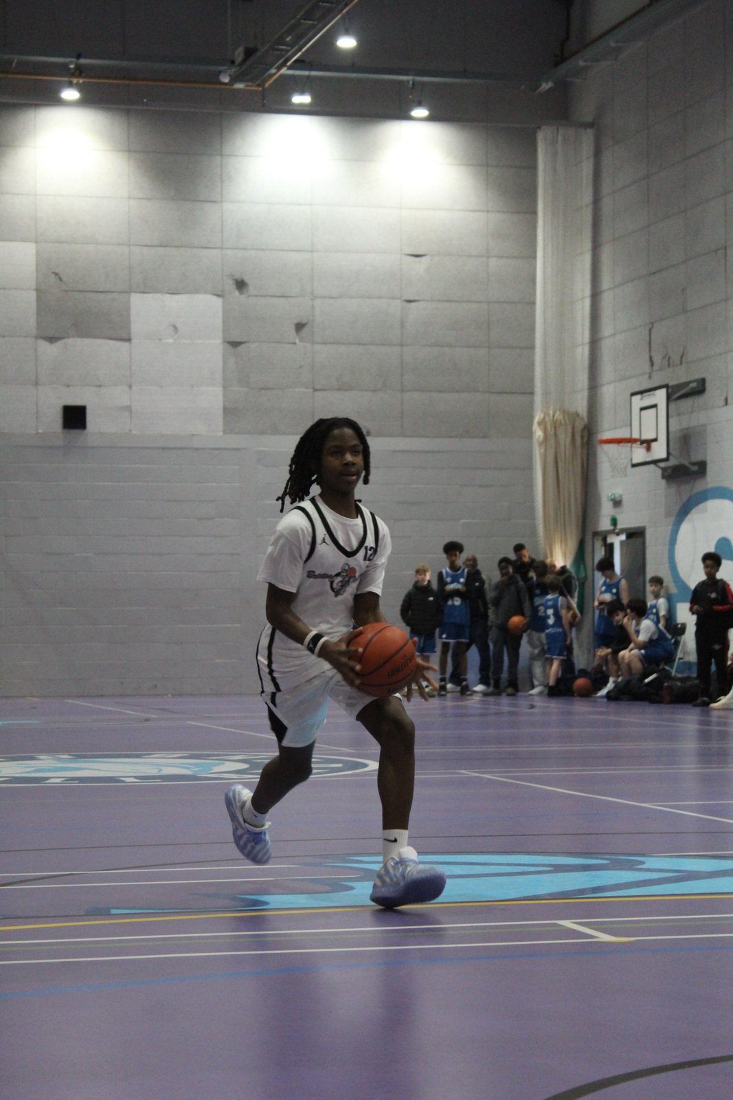 A Brixton Topcats Under-13 player dribbling up court in the 2026 BDL final