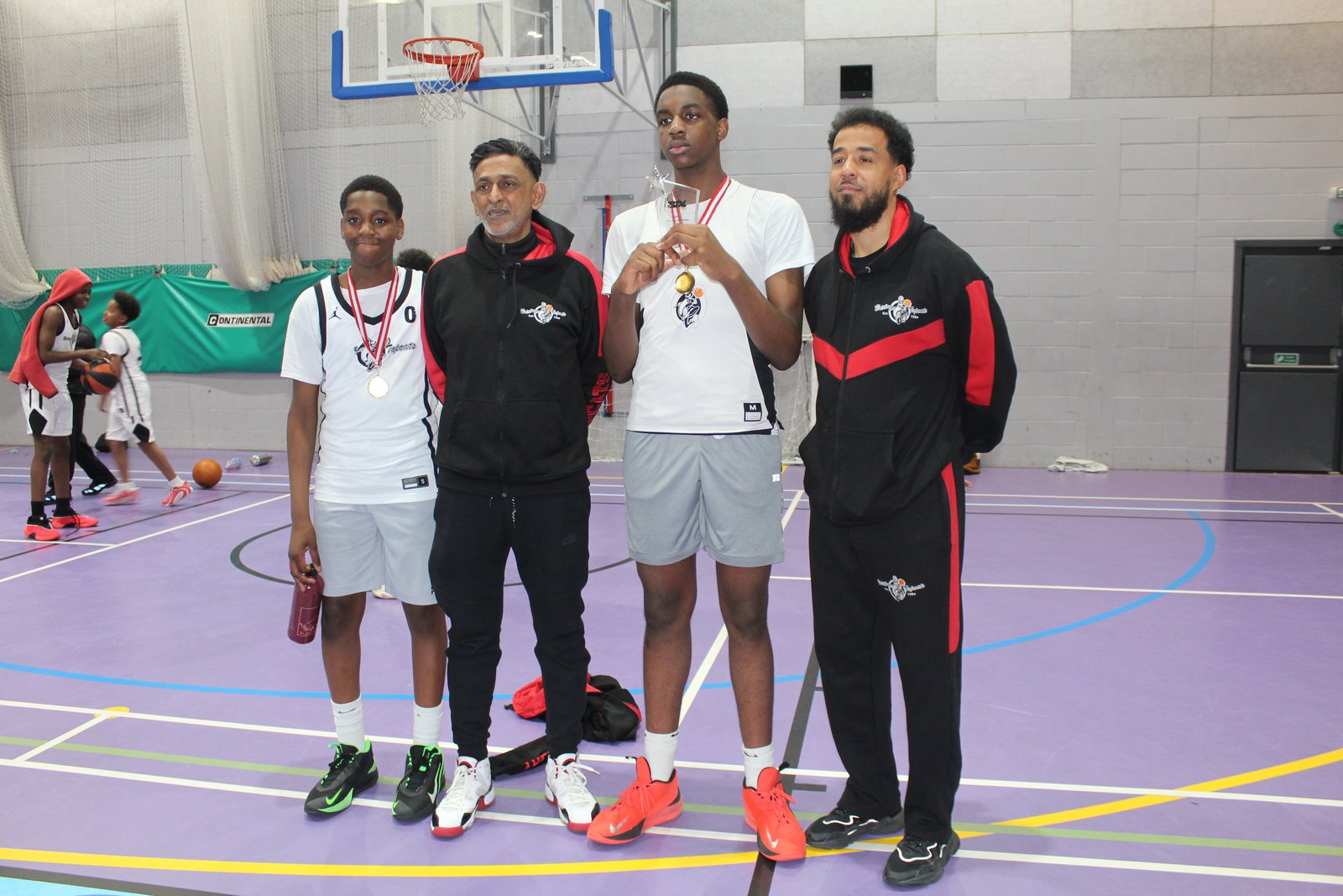 Brixton Topcats coaches and players celebrate the 2026 BDL title