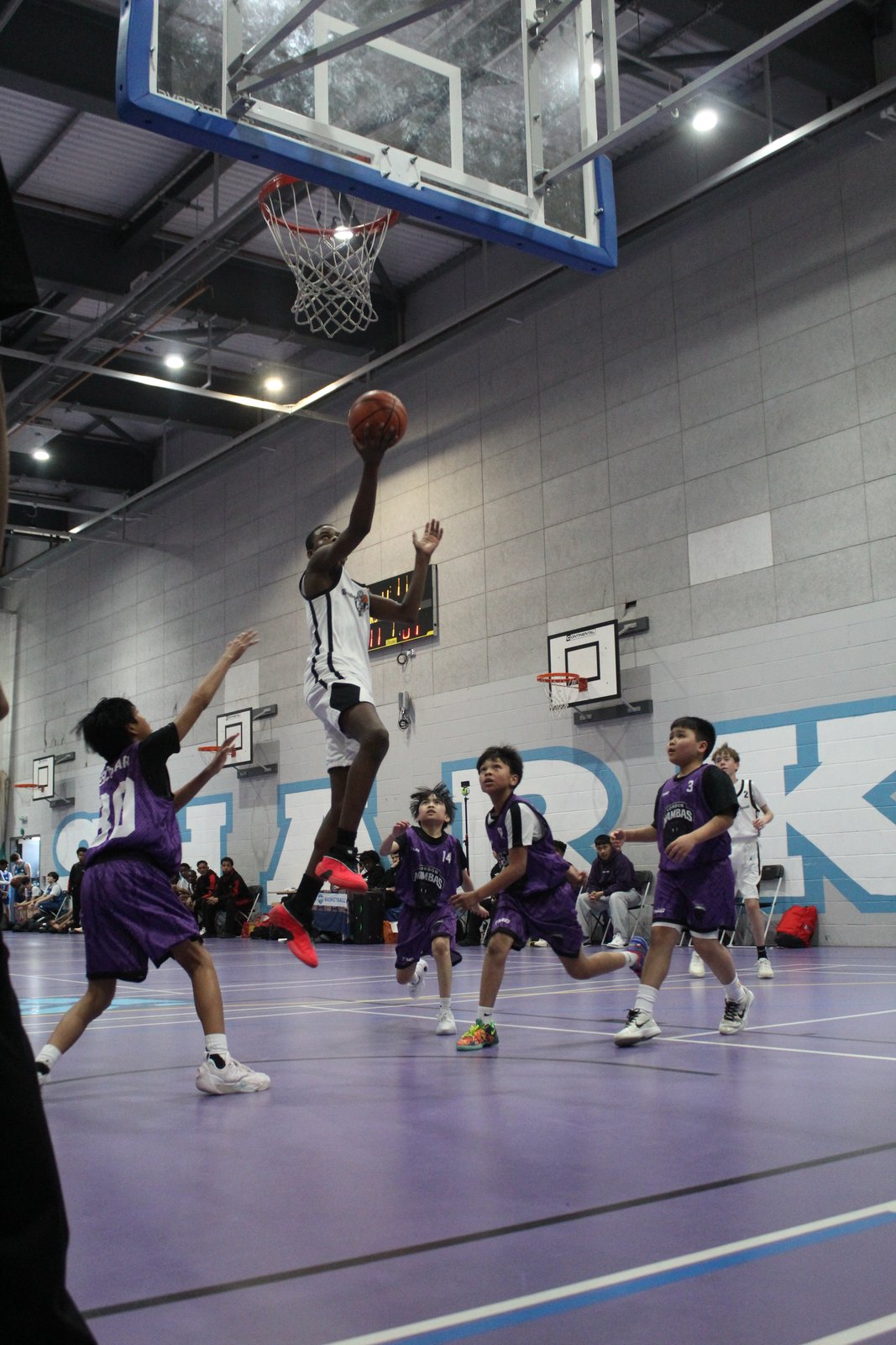 Brixton Topcats Under-13 player finishing at the rim
