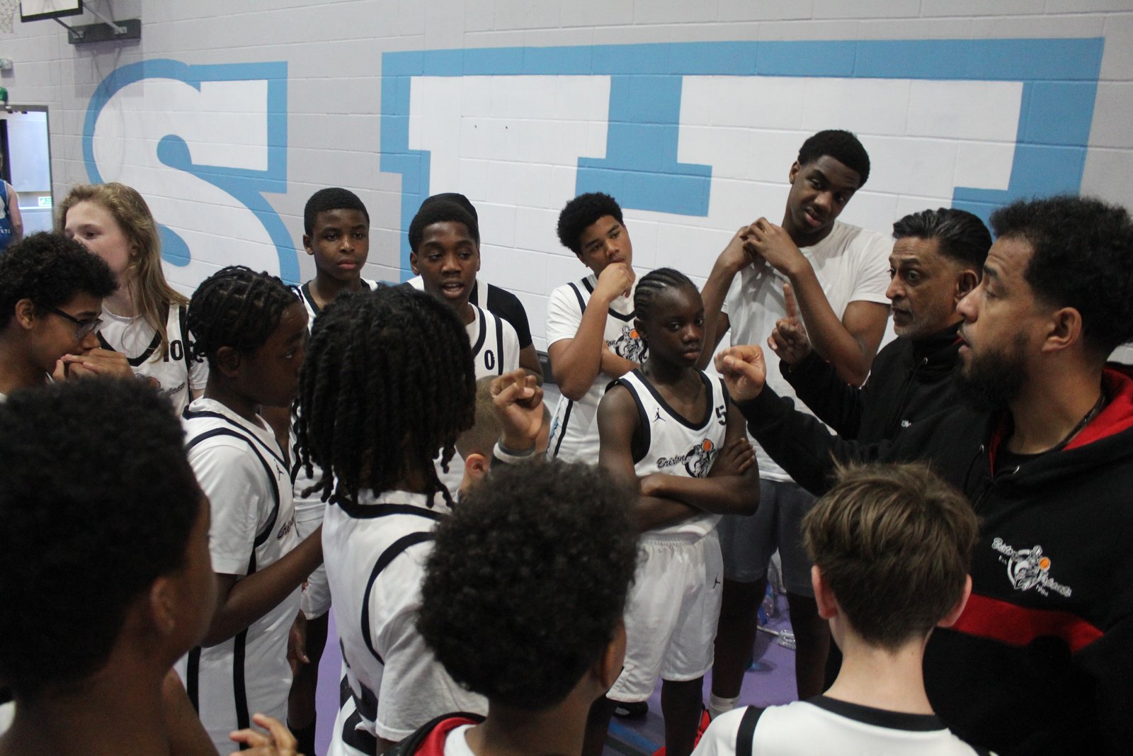 Brixton Topcats Under-13s huddle with their coaches