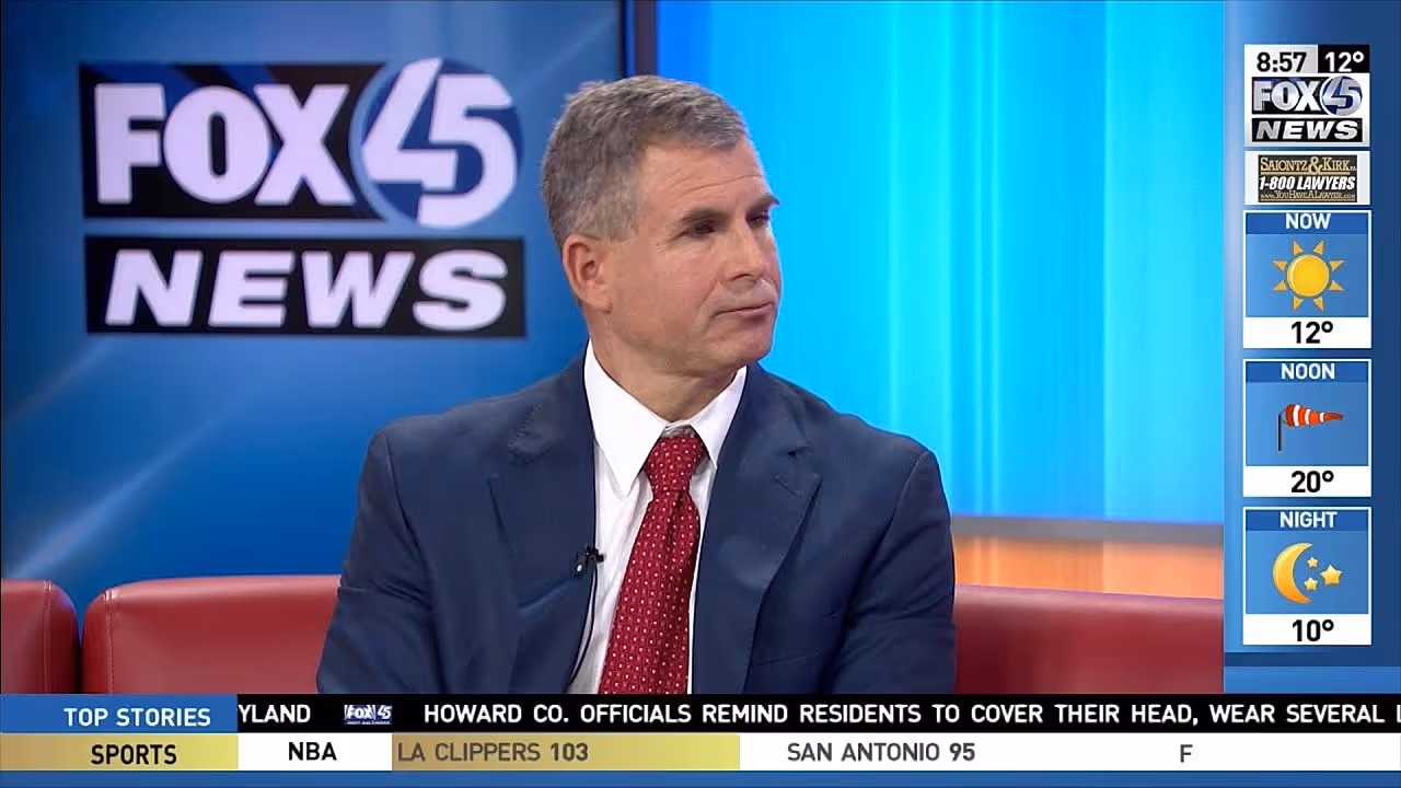 A man in a suit and red tie sitting on a television studio set, with the Fox 45 News logo visible in the background.