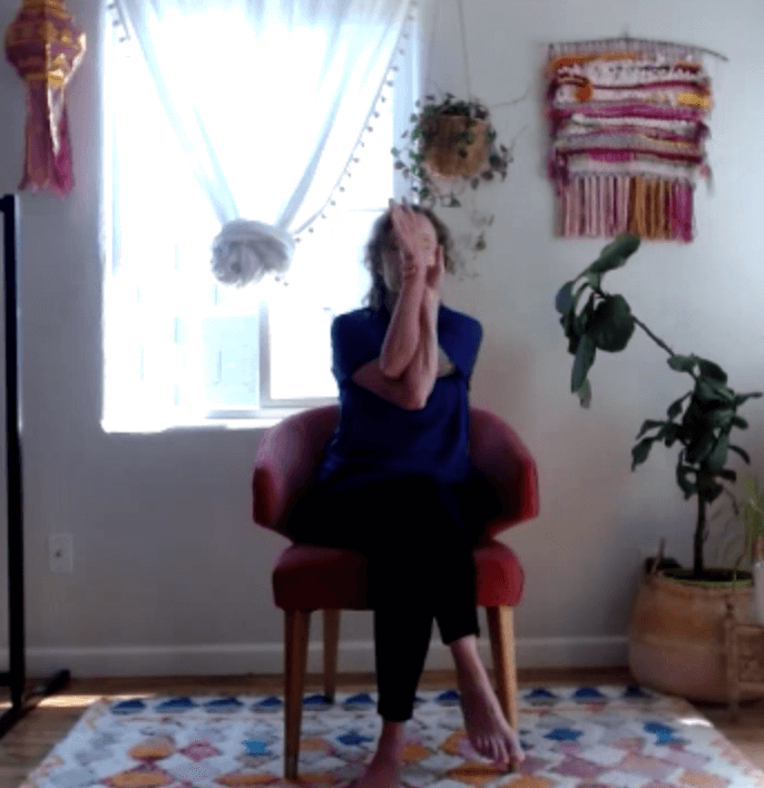 televeda yoga instructor in seated eagle pose 