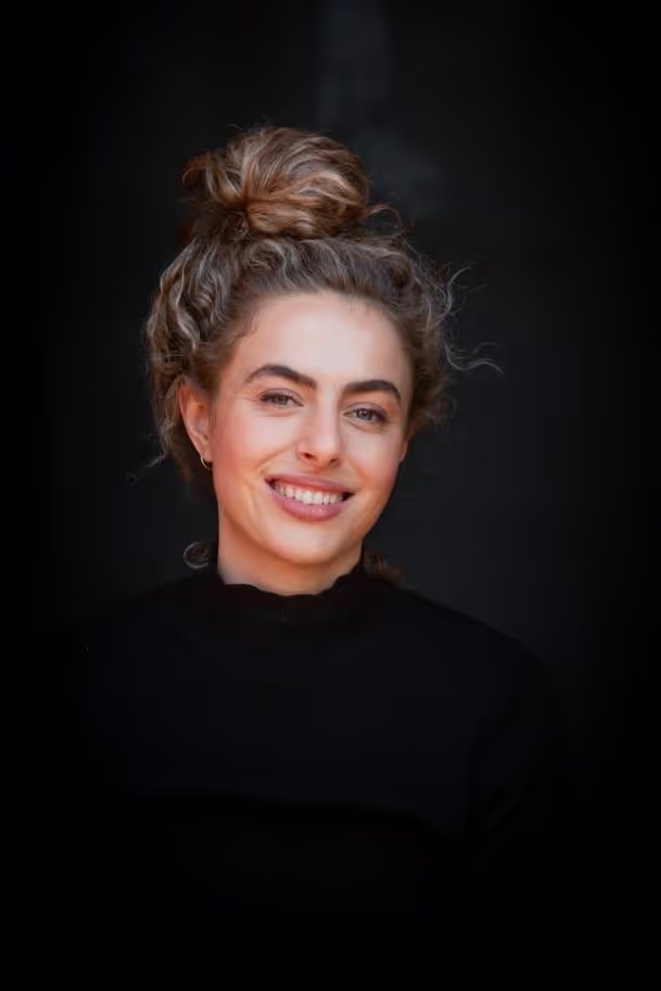 Portrait of a smiling woman with her hair in a bun