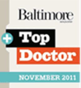 A logo featuring the text 'Baltimore Magazine' in black and uppercase letters, with a blue plus sign and the words 'Top Doctor' in bold orange and black text, followed by 'NOVEMBER 2011' in smaller text.