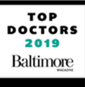The text 'TOP DOCTORS 2019' is displayed in bold black letters with a turquoise color for the year '2019'. Below it, the words 'Baltimore MAGAZINE' are shown in a stylized black font.