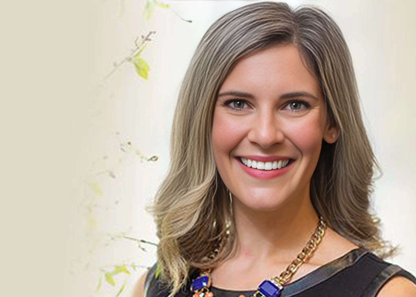 Professional headshot of Dr. Kelsey Suppa, wearing a dark sleeveless top and gold chain necklace, photographed against a soft light background.