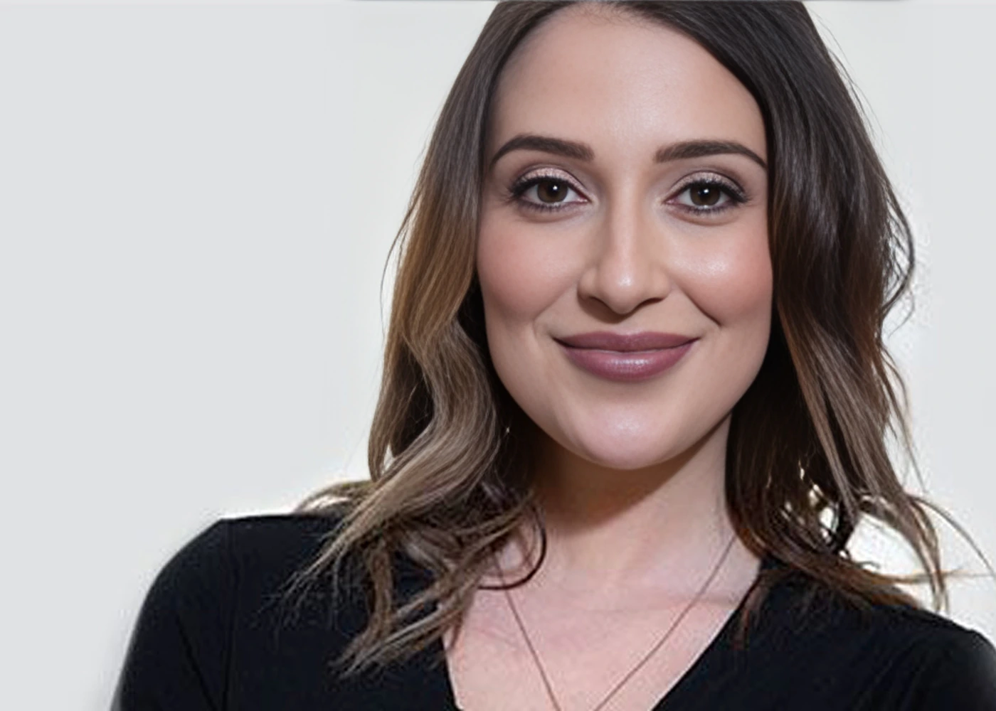 Professional headshot of Dr. Angela Salango, wearing a black V-neck top and gold necklace, smiling warmly at the camera.