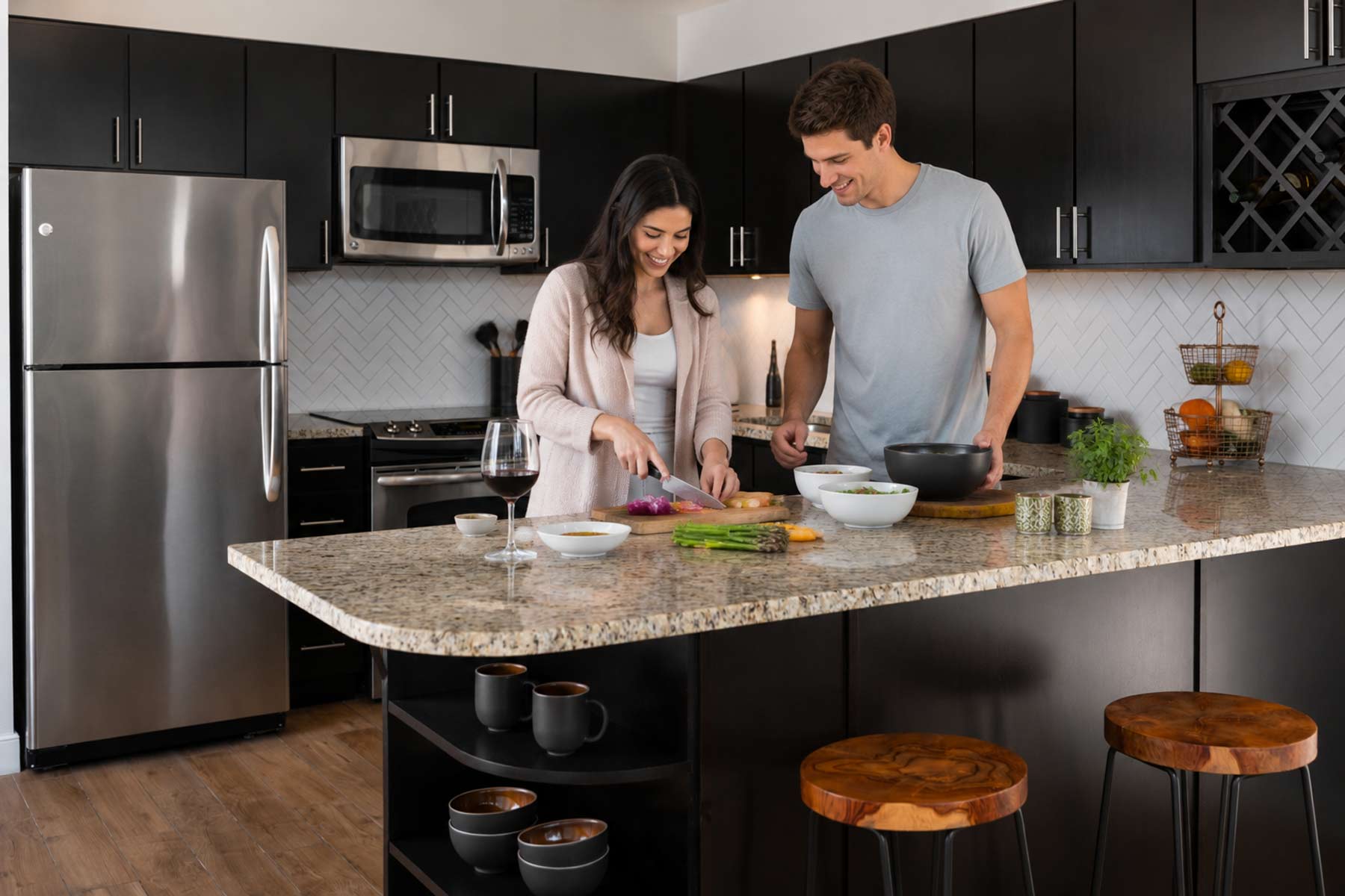 Couple preparing dinner at an apartment kitchen island