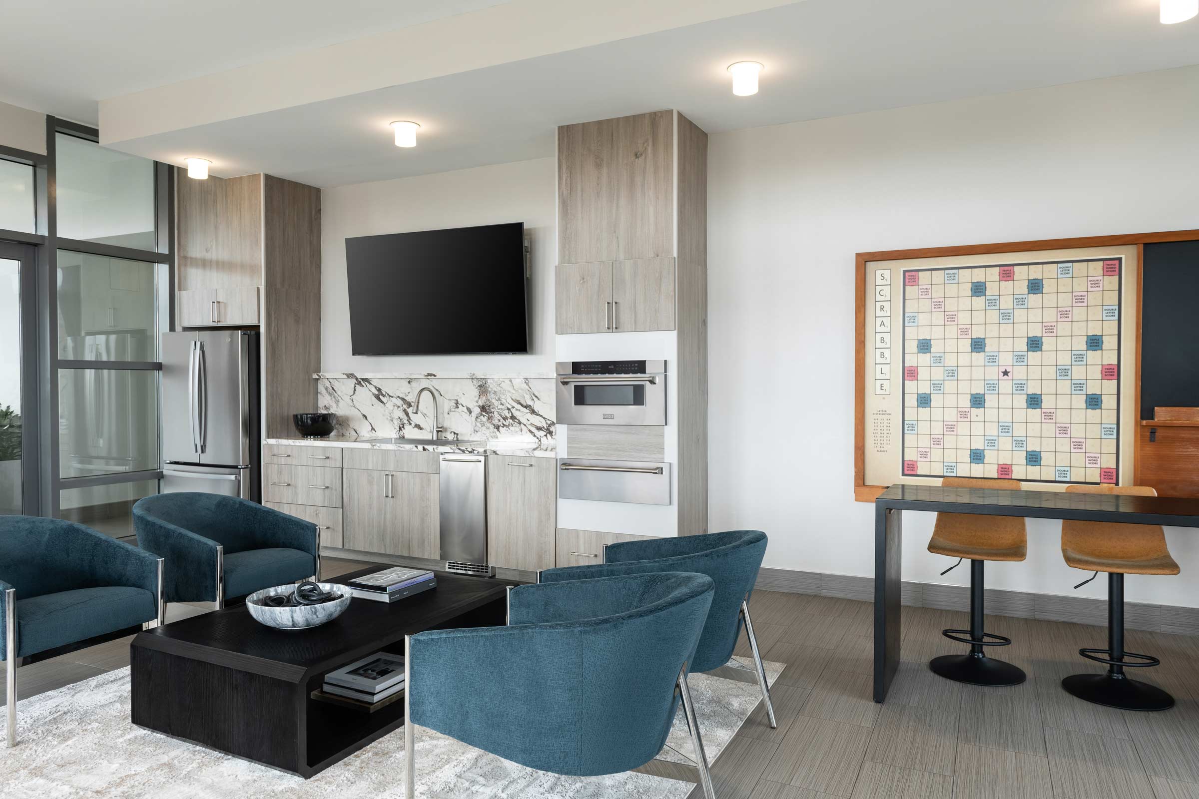 Lyric rooftop lounge with seating, a shared kitchen, and a wall-mounted game board
