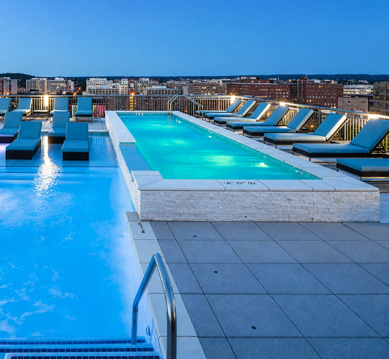 Illuminated rooftop pool and lounge chairs at Lyric 440 at dusk