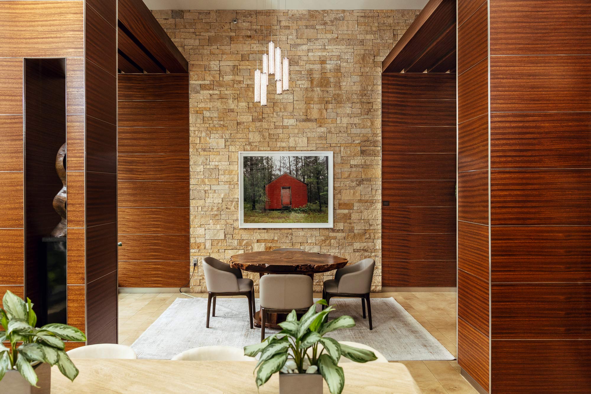 Lyric 440 lobby with wood-paneled walls, pendant lighting, and a shared table