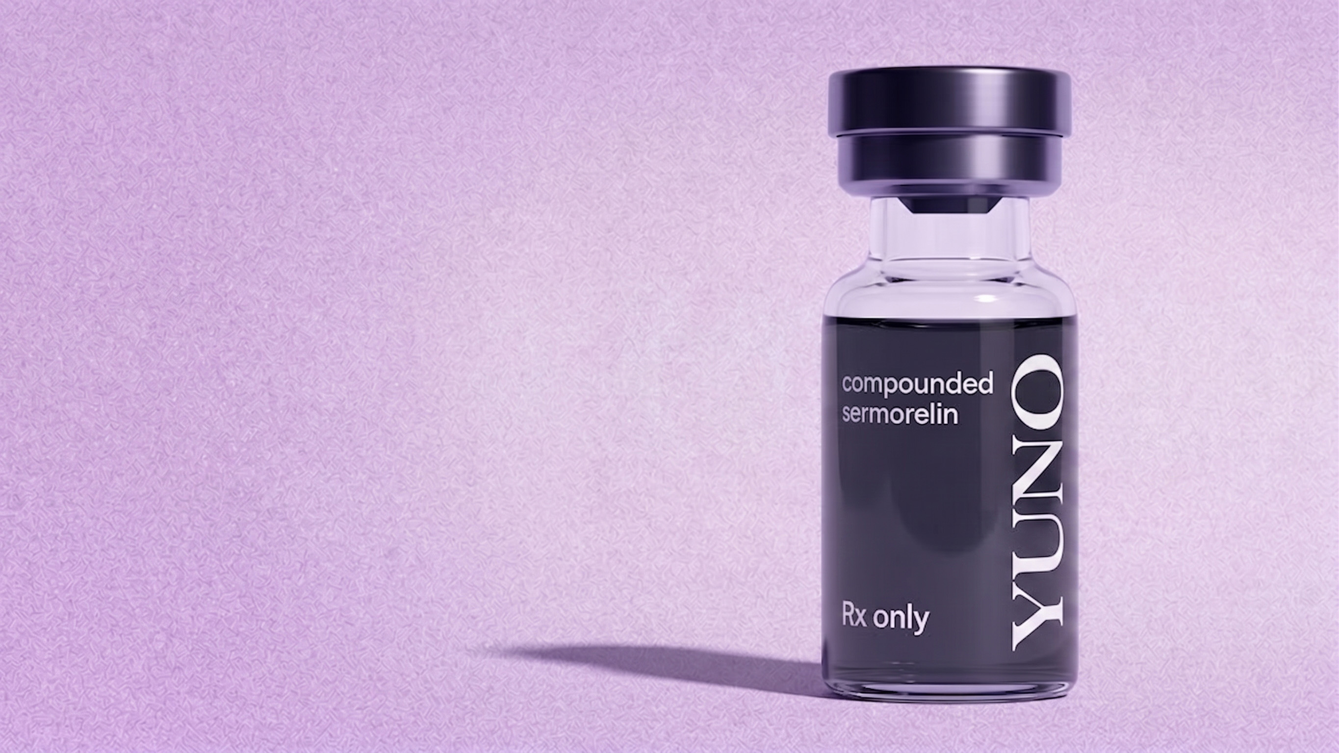 Small clear vial with a black cap labeled 'compounded sermorelin,' 'Rx only,' and 'YUNO' on a textured lavender background.
