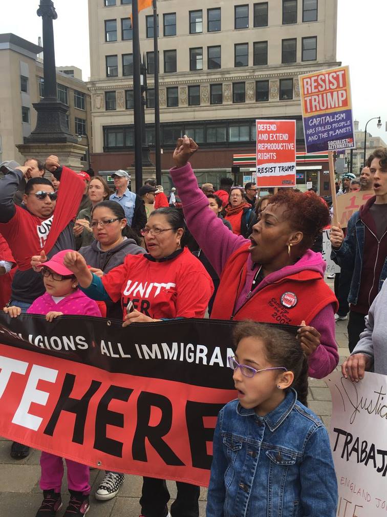 NEJB members marching with an All Immigrants, All Workers banner