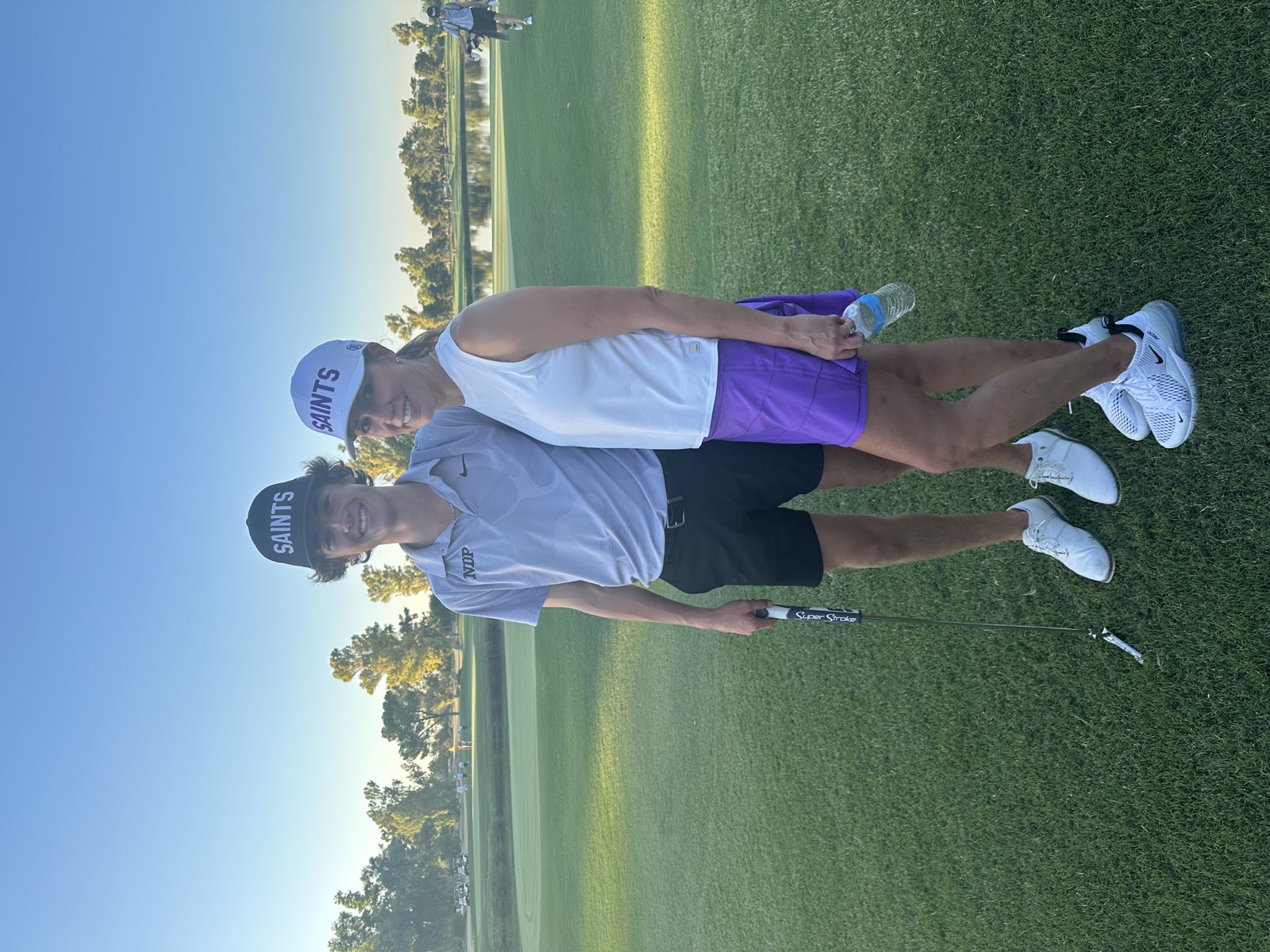 Christi Wolfe's son swinging a golf club at DC Ranch Country Club at sunset