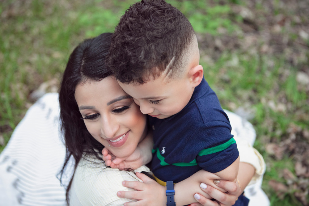 Sabreen Rihan embracing her son Adriyan Isa in the woods.
