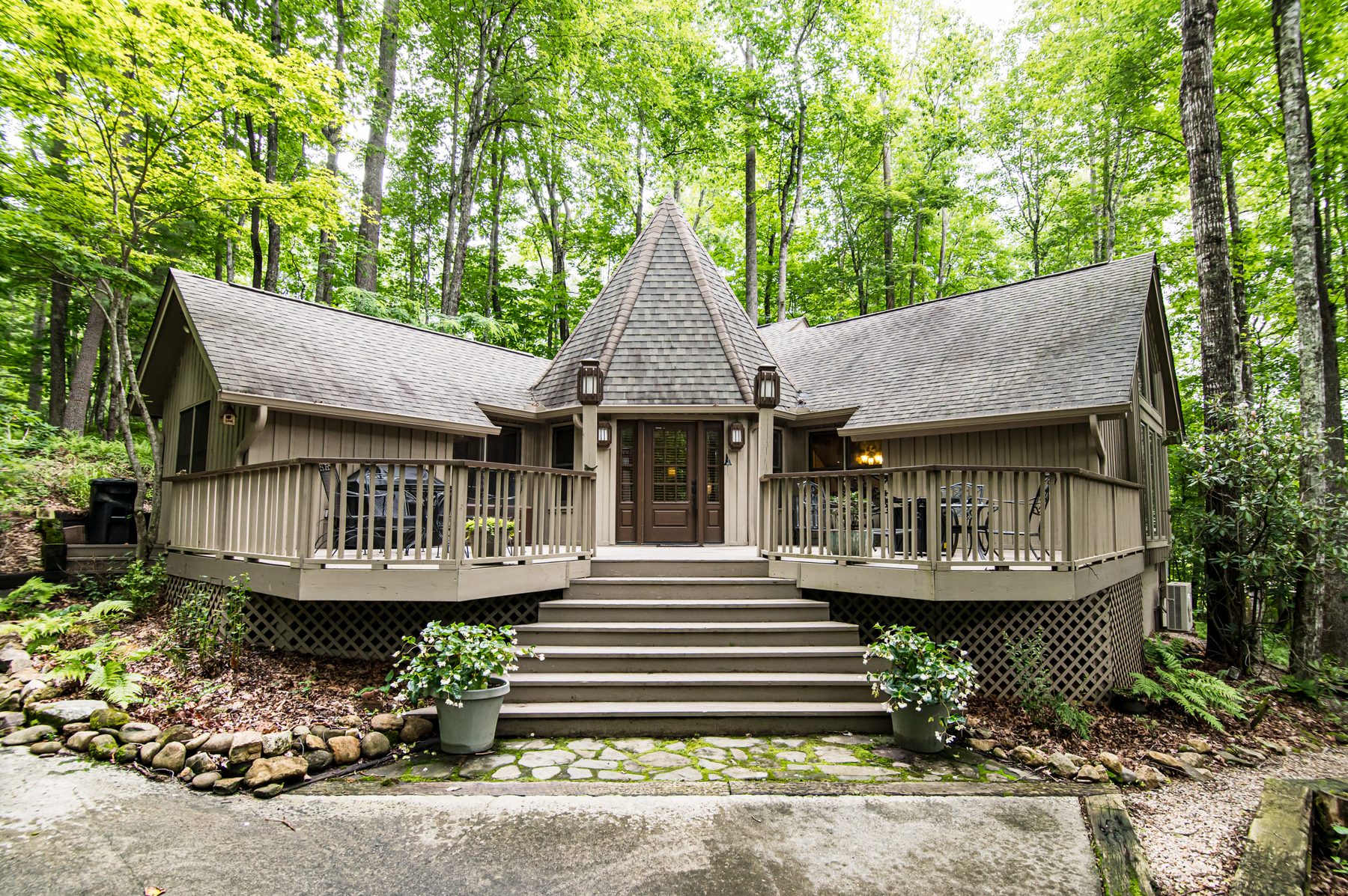 Front exterior of The Woodland Cottage in Sapphire NC with its cedar-shingled turret and wraparound porch