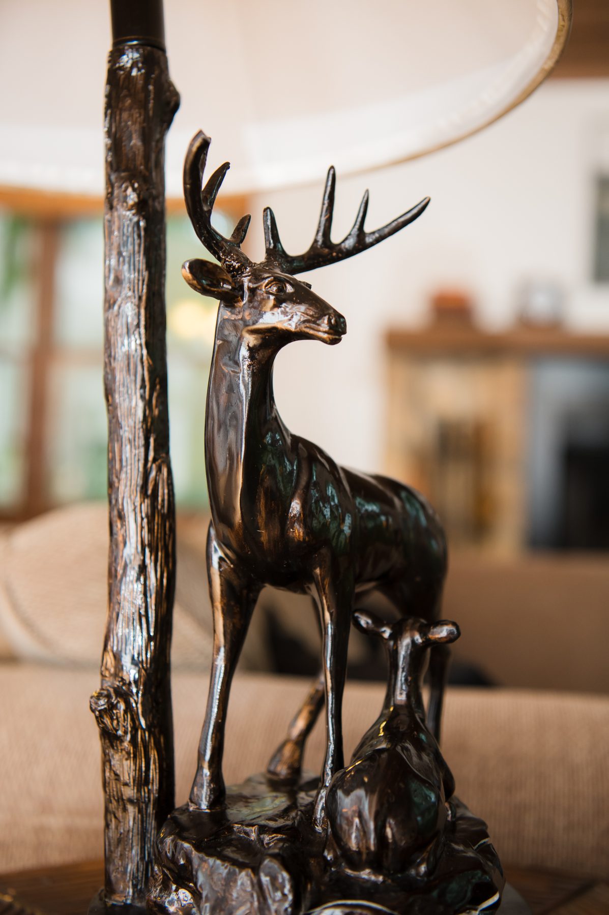 Bronze stag lamp detail in the living room of The Woodland Cottage, part of its woodland-lodge décor