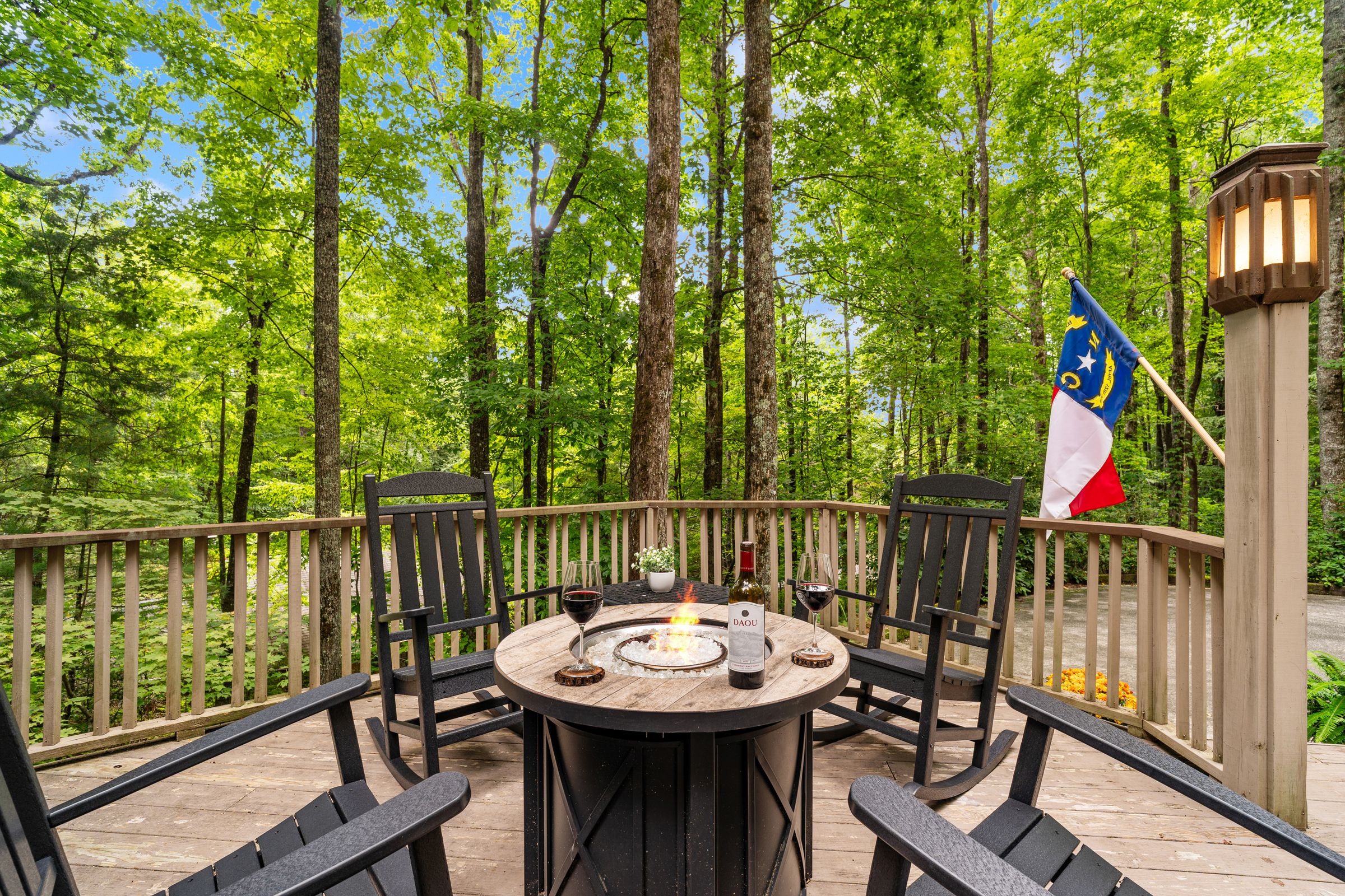 The gas firepit on the deck, ringed by rocking chairs