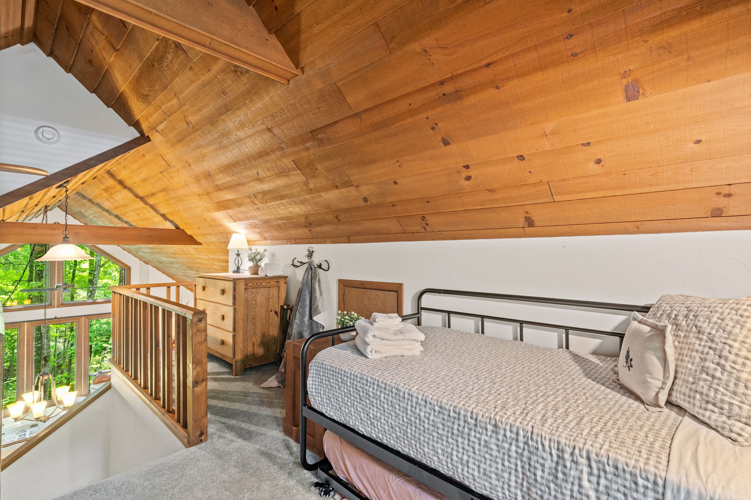 The loft, with a twin daybed and the railing overlooking the great room