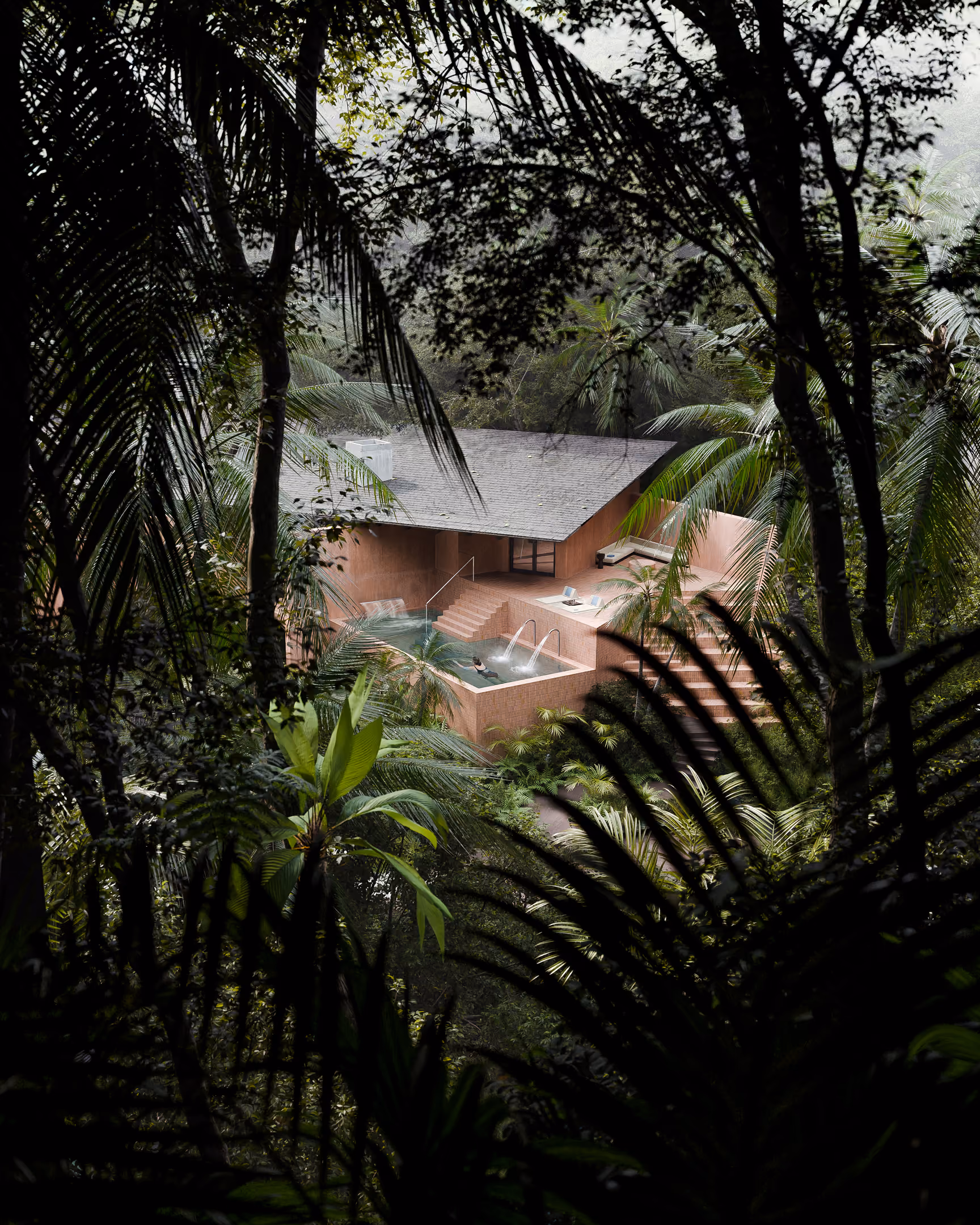 A pink sand-colored building with outdoor Thalassotherapy pool is seen through lush tropical forest vegetation.