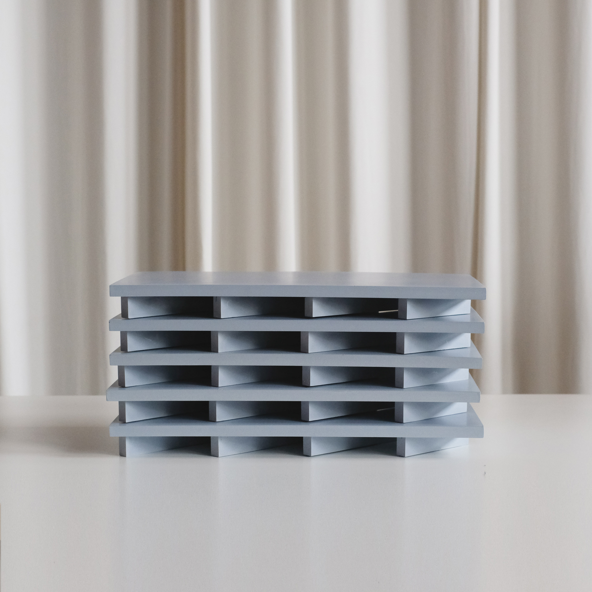 Stack of pale blue custom retail display tools fabricated for the Valextra store in Honolulu.
