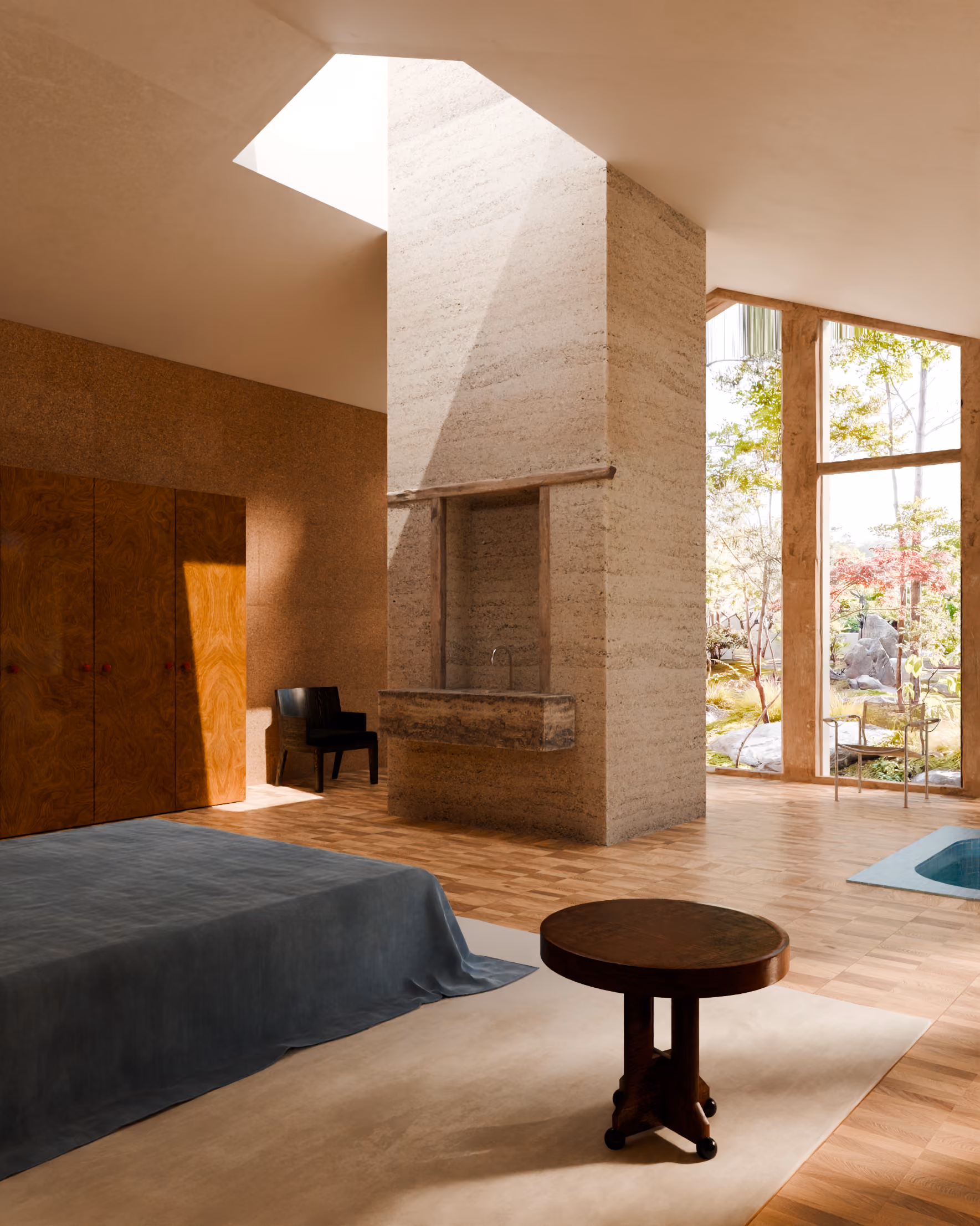 Modern bedroom with wooden floor, large windows, a bed with blue linen, and a central stone pillar with a sink.