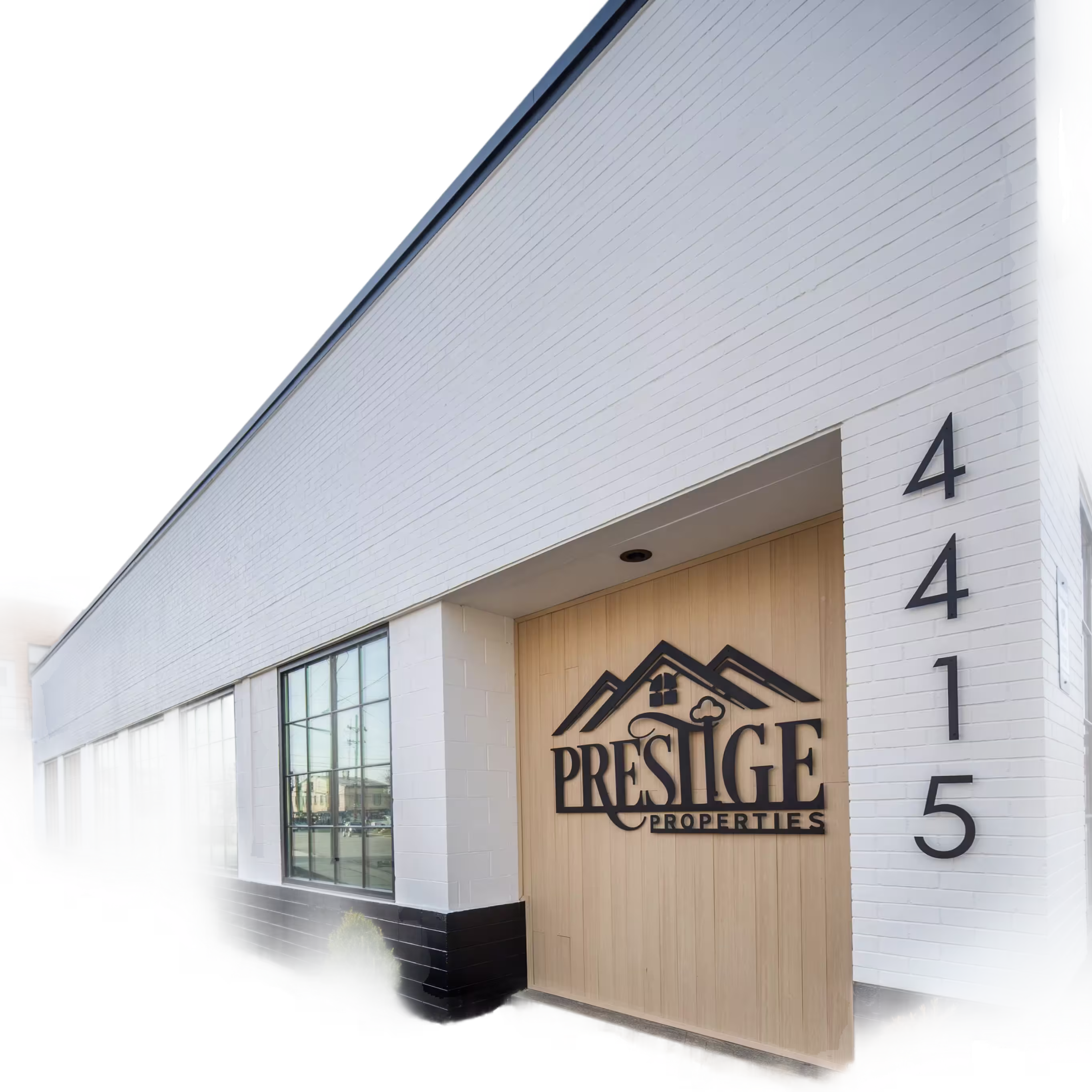 Modern exterior of the Prestige Properties office building located at 4415, featuring a prominent logo with a mountain motif