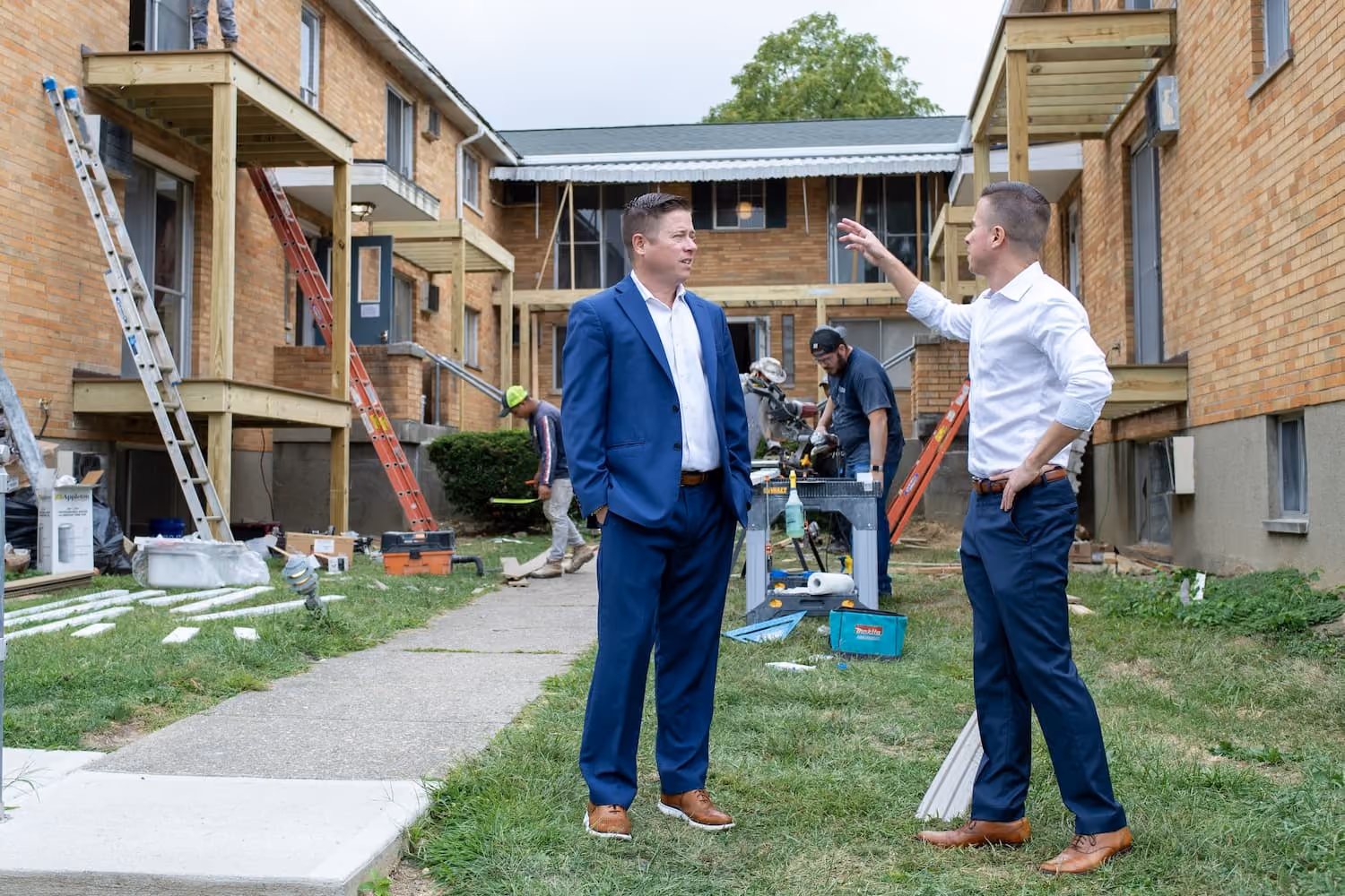 Mitch Painter inspecting exterior apartment balcony construction progress at Prestige Properties