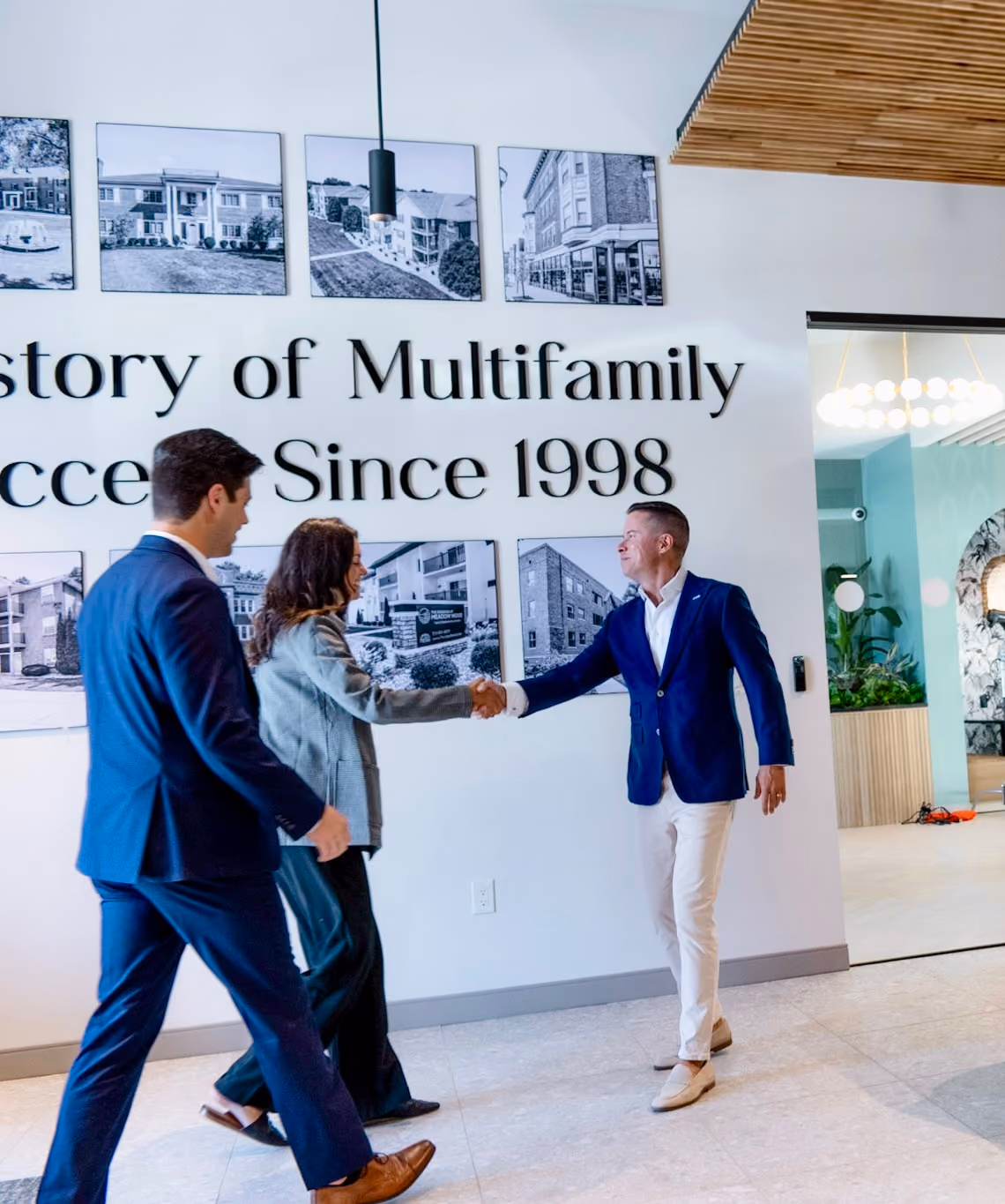 Mitch Painter shaking hands with clients at the Prestige Properties office