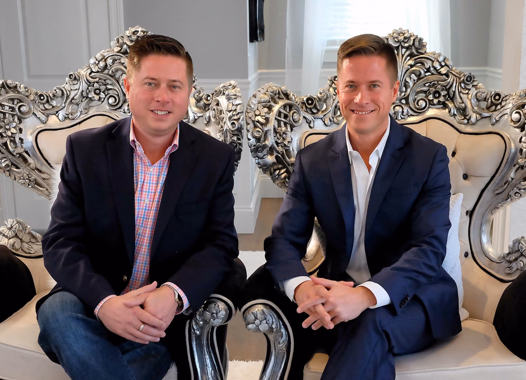 Matt Painter and Mitch Painter seated in ornate silver armchairs representing Prestige portfolio expansion in 2010
