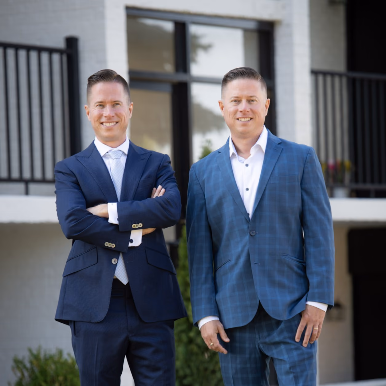 Mitch Painter and Matt Painter standing outside an apartment building marking 1,000+ completed transactions in 2015