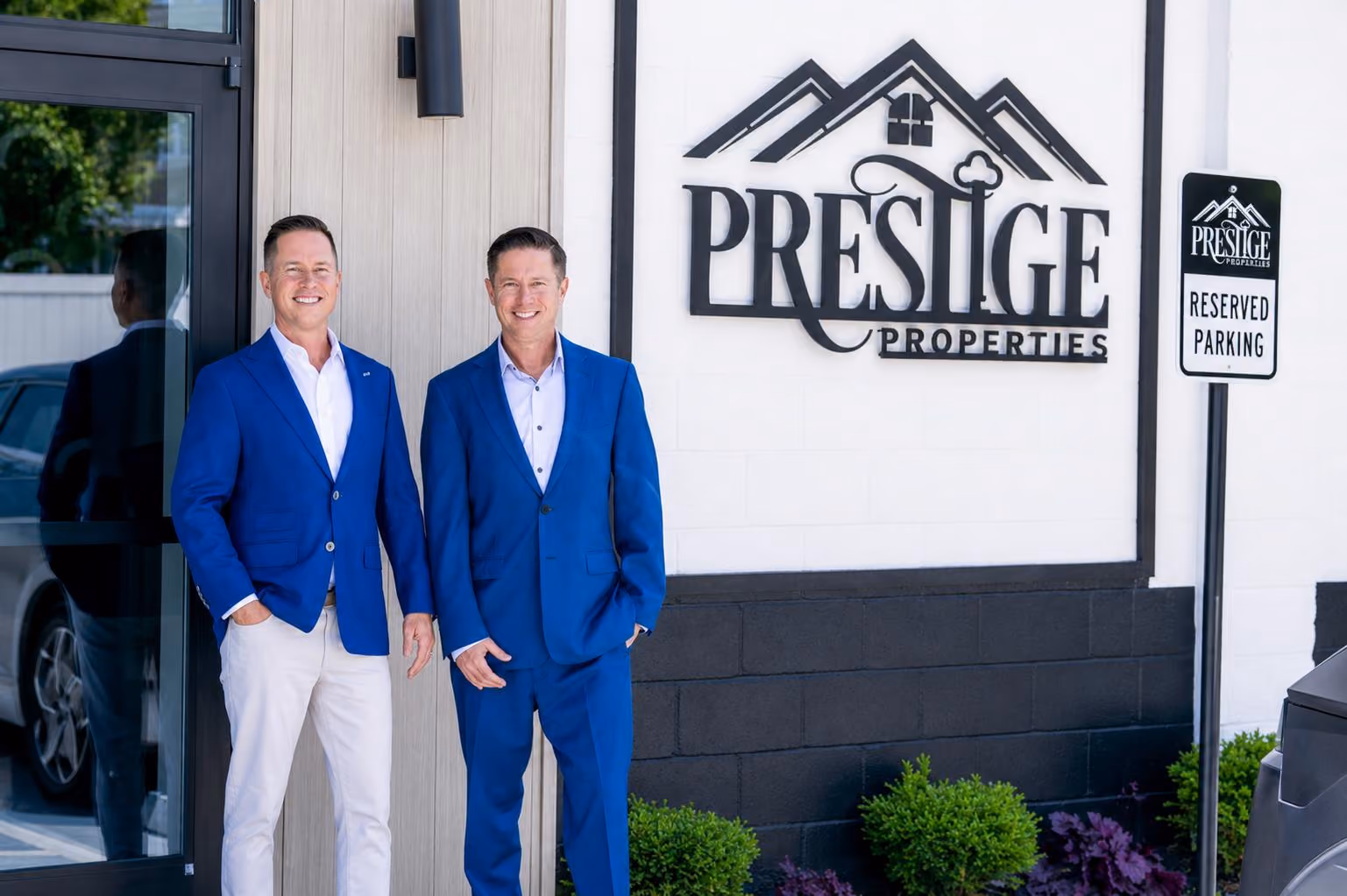 Mitch Painter and Matt Painter standing outside the Prestige Properties headquarters building