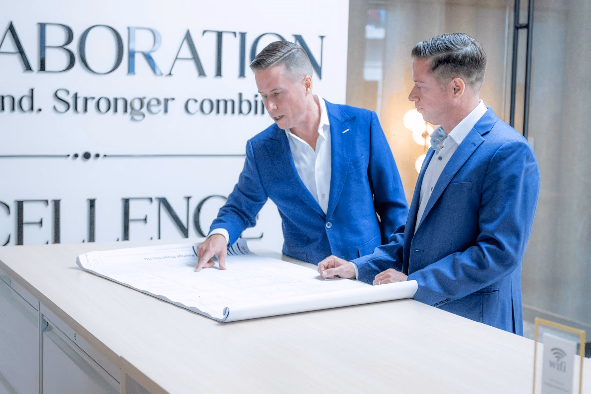 Mitch Painter and Matt Painter reviewing architectural site plans together at a table