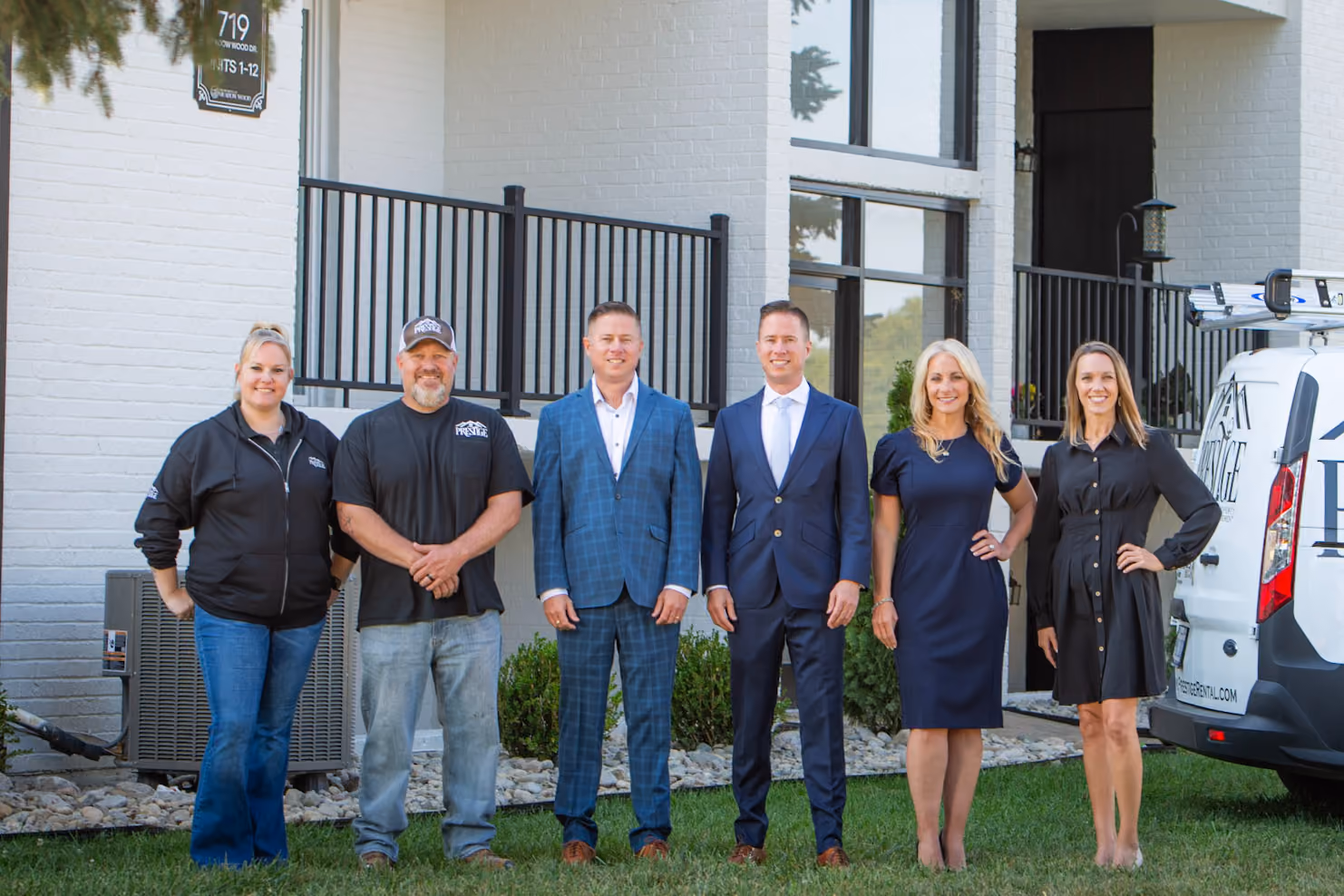 Mitch Painter, Matt Painter, and the Prestige Properties team standing together outside a managed apartment property