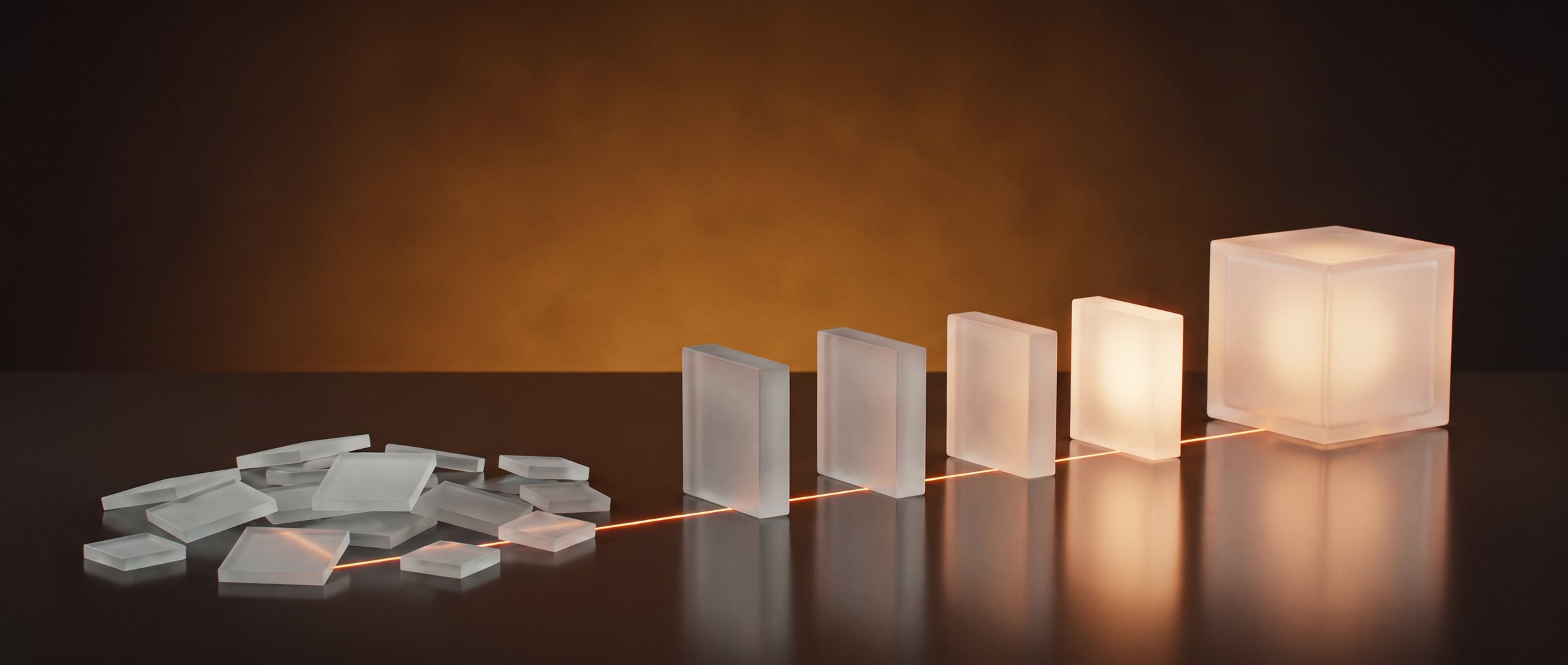 A loose pile of frosted glass tiles on a dark table, joined by one orange light line to a row of upright glass blocks that ends in a glowing glass cube
