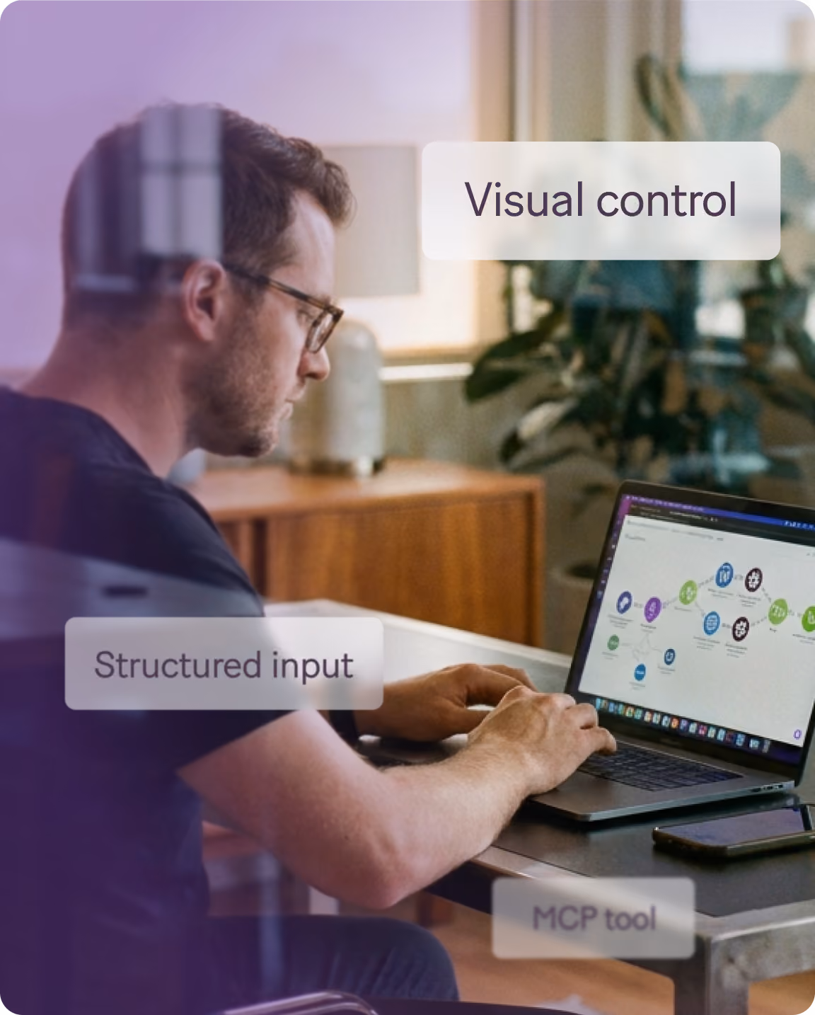 Man at a laptop building with visual control and structured inputs