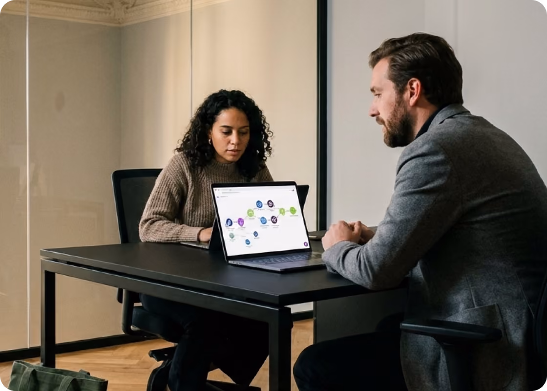 Founders reviewing a Make scenario on a laptop