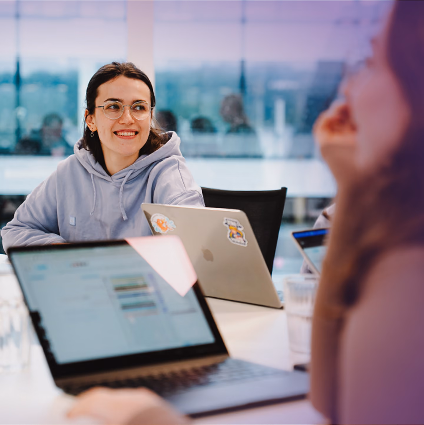 Make employee smiling at her laptop in the office